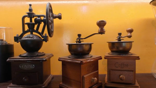 Grinding Vietnamese coffee beans during a coffee experience in Hoi An