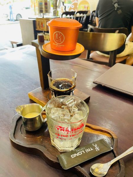 Vietnamese phin coffee slowly dripping into a glass