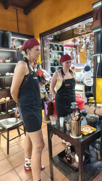 Tourist making Vietnamese coffee with a traditional phin filter