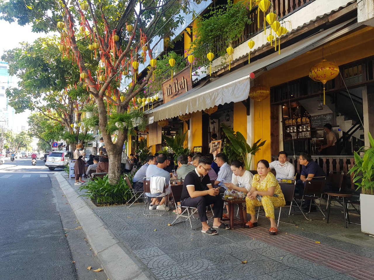 Vietnamese people enjoying coffee on a sidewalk