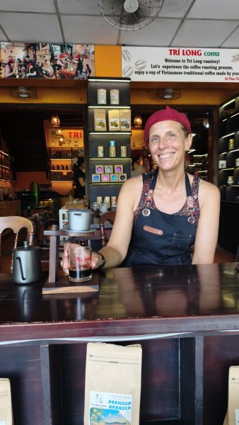 Tourist enjoying Vietnamese phin coffee