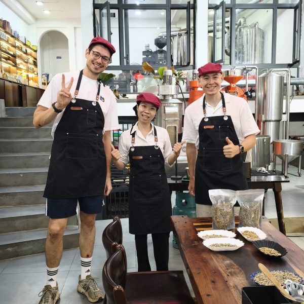 Guests learning about green coffee beans during a coffee roasting experience in Hoi An