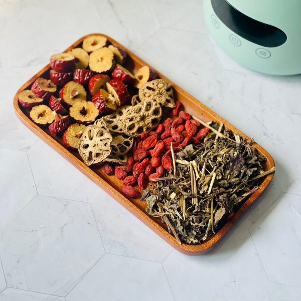 Vietnamese herbal tea with lemongrass, lotus, butterfly pea flowers, ginger and dried fruits