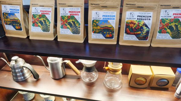Packing freshly roasted coffee during an advanced coffee roasting class in Hoi An