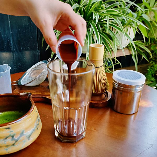 Pouring chocolate to make a matcha chocolate drink