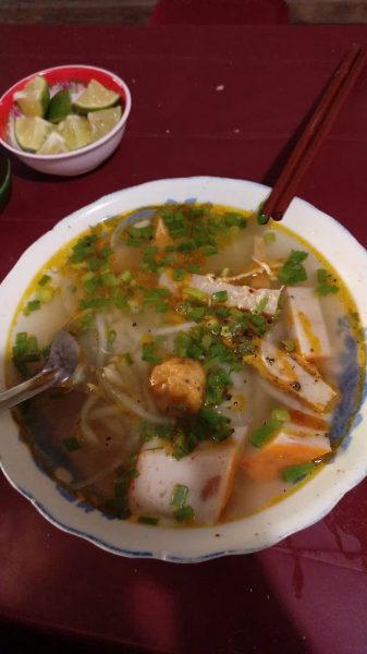 Vietnamese banh canh noodle soup with thick noodles, shrimp, pork and fresh herbs