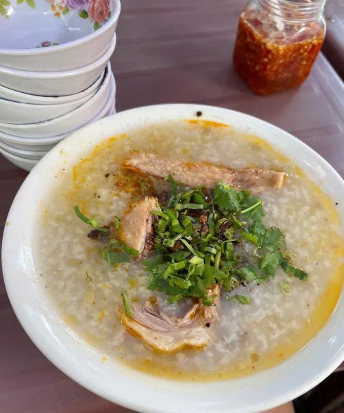 Vietnamese duck porridge with tender duck meat, rice porridge, green onions and fresh herbs