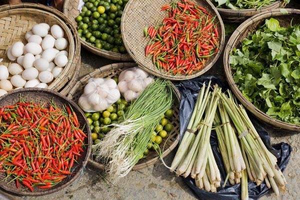 Fresh herbs, lemongrass, chilies and local vegetables at a traditional market in Hoi An, Vietnam.
